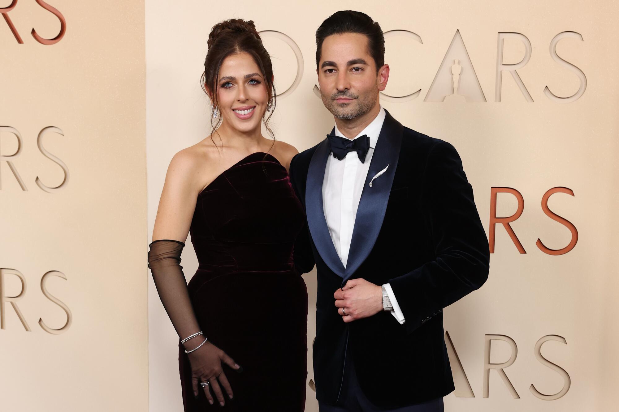 Natalie Qasabian and Sev Ohanian pose on the red carpet. 