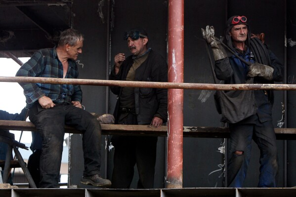 Workers stand together at a shipyard in Gdansk, Poland, Aug. 23, 2007. (AP Photo/Czarek Sokolowski, File)