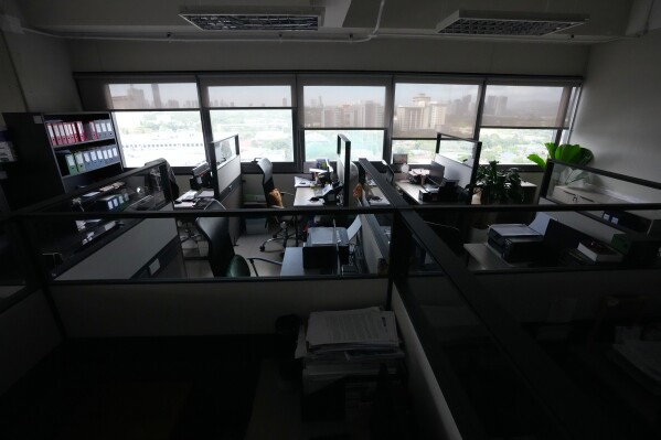 Desks remain at an empty office at the Metropolitan Manila Development Authority closed due to the implementation of four-day work week on Friday, March 13, 2026 in Pasig, Philippines. (AP Photo/Aaron Favilal)