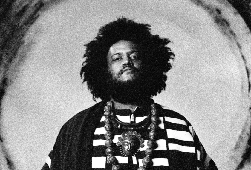 A black-and-white portrait of Kamasi Washington.
