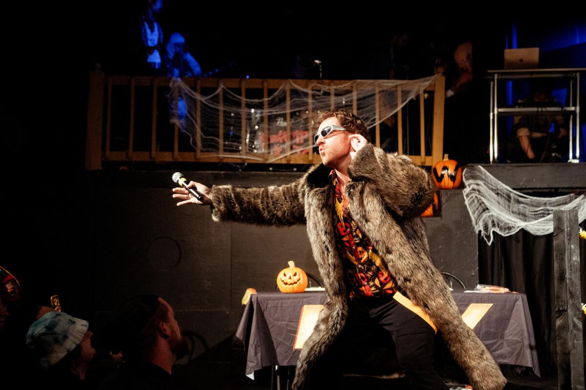 Shane Hartline dons a fur coat during a dramatic entrance in the "NAW or Never" live comedy wrestling show.
