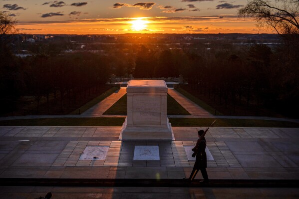 A U.S. Army honor guard member stands vigil at dawn at the Tomb of the Unknown Soldier on Tuesday, March 17, 2026, at Arlington National Cemetery in Arlington, Va., ahead of the 100th anniversary of a continuous honor guard presence at the tomb, celebrated March 25, 2026. (AP Photo/Mark Schiefelbein)