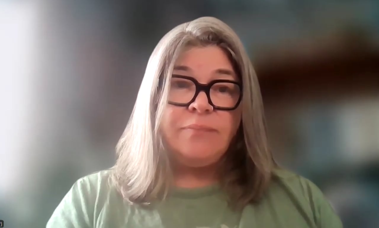 A woman on a Zoom screen with glasses