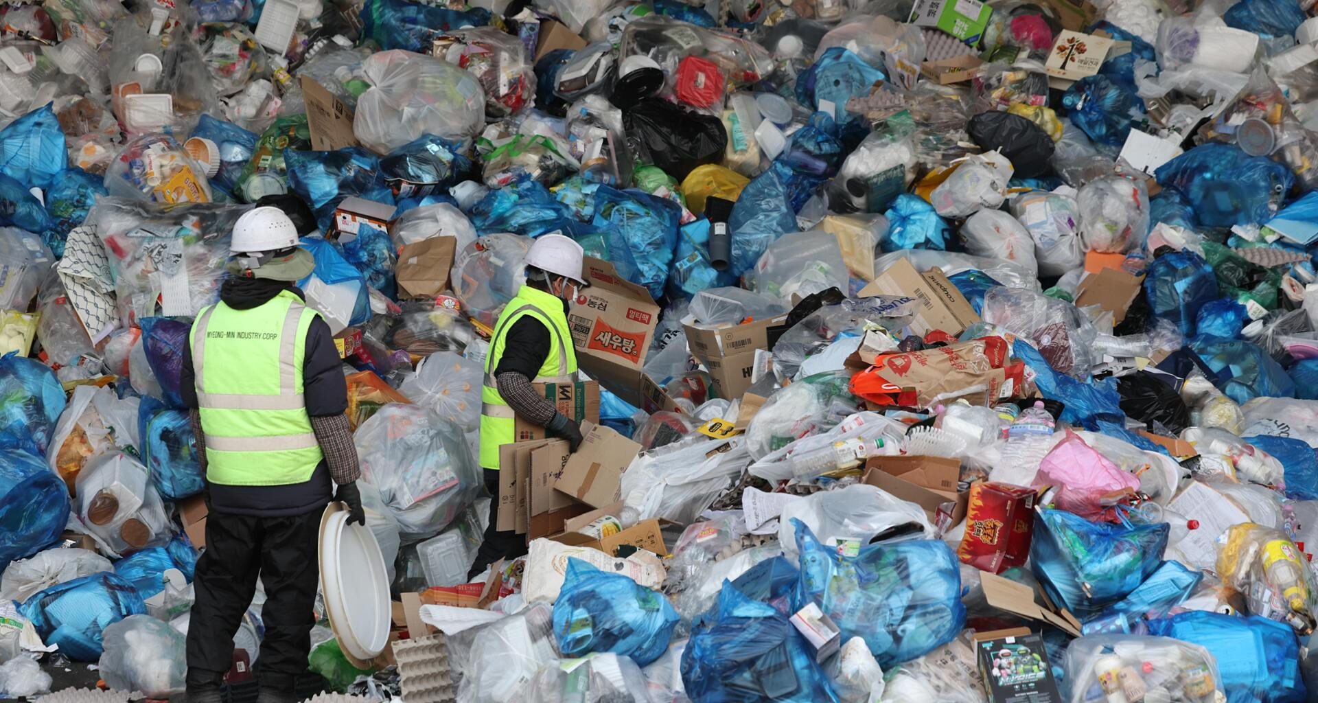 Piles of waste are stacked at a recycling sorting facility in Seoul. / Yonhap