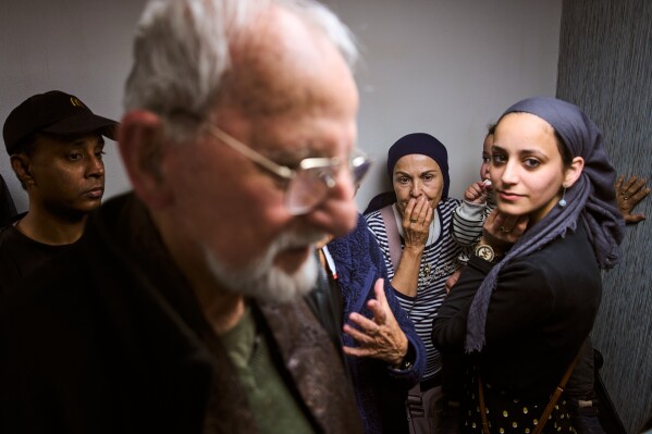 People take cover in a bomb shelter beneath a shopping mall as air raid sirens warn of incoming missiles from Iran in Ramat Gan, Israel, Tuesday, March 17, 2026. (AP Photo/Oded Balilty)
