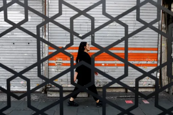 A woman walks on a street in Tehran, Iran, March 22, 2026. 