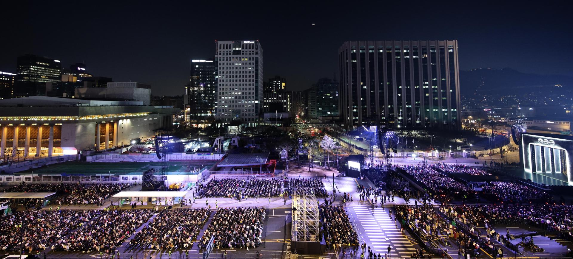 BTS fans are seated at the concert venue at Gwanghwamun Square in Seoul, March 21, before the comeback concert. Joint Press Corps