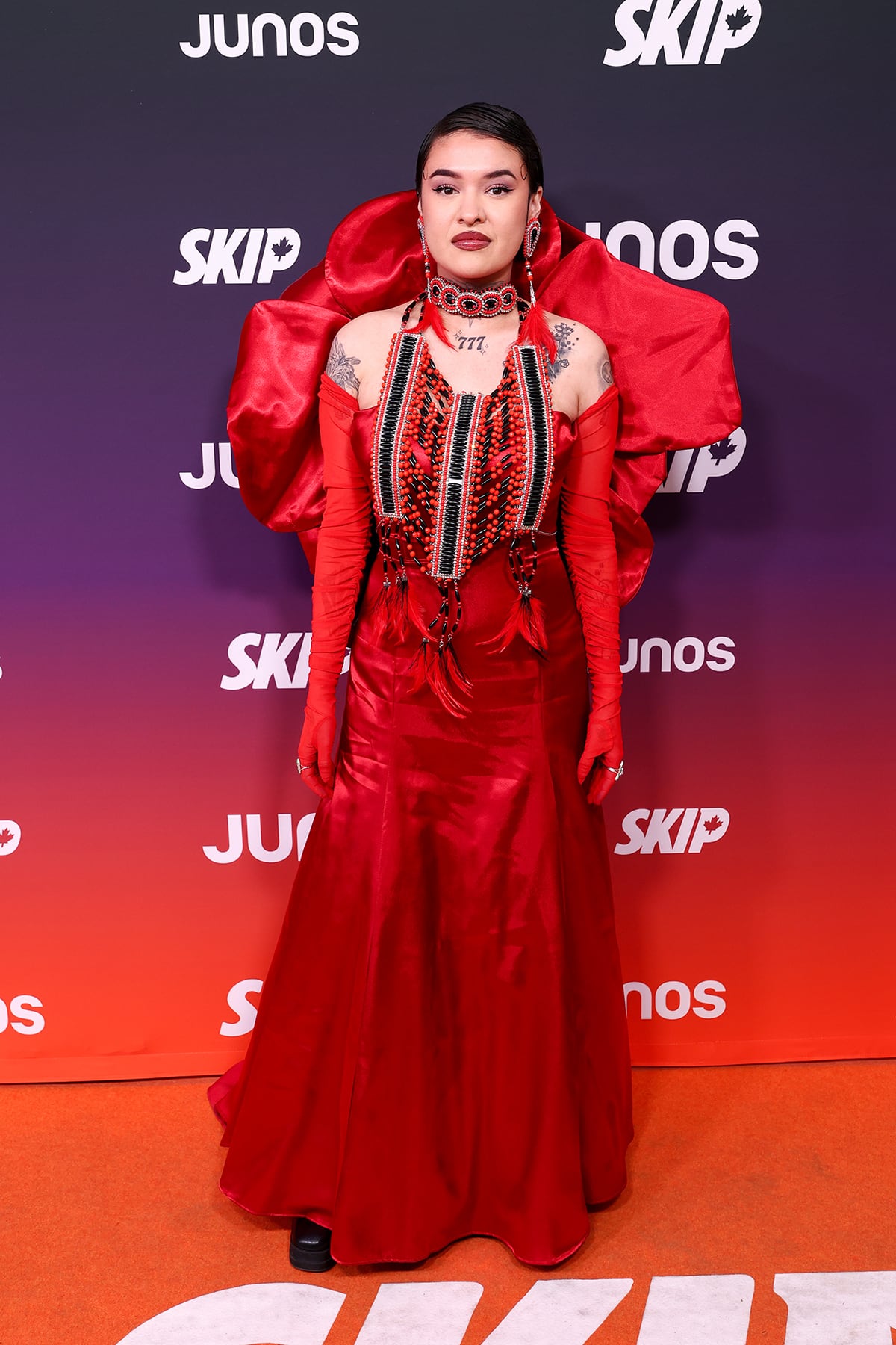 A woman poses for photos in an all-red ensemble.