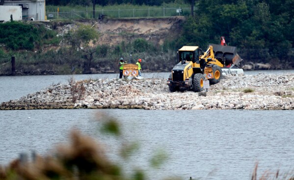 Work continues at San Jacinto River Waste Pits, a Superfund site, near the Interstate 10 bridge over the river in Channelview, Texas on Sept. 13, 2017. (AP Photo/David J. Phillip, File)