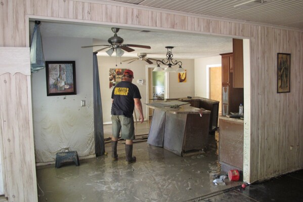 Dwight Chandler walks through his devastated home from Hurricane Harvey not too far from old acid pits that were designated as a U.S. EPA Superfund in Highlands, Texas, Aug. 31, 2017. (AP Photo/Jason Dearen, File)