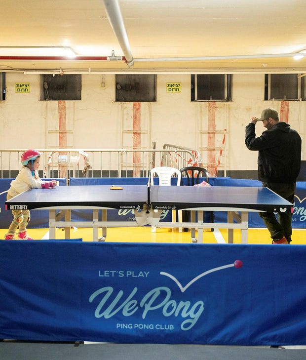 Table tennis at Dizzengof Center's underground parking lot/bomb shelter on Monday. The air quality may not be great and it can be noisy, but the risk of missile-related injuries is low.