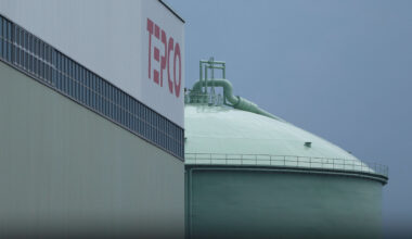 Palestinians sell bread on a street beneath a destroyed building in Gaza City's Zawiya market on February 18, 2026, on the first days of the holy fasting month of Ramadan.