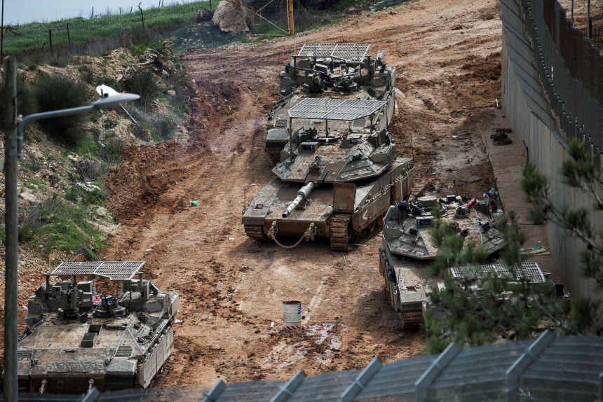 Israeli military vehicles at the Israel-Lebanon border following an escalation between Hezbollah and Israel, on Friday.