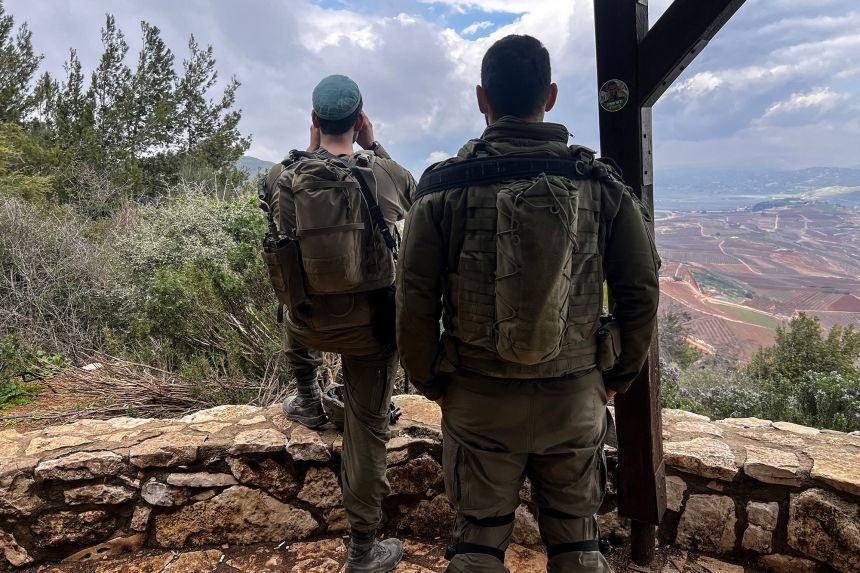Israeli soldiers look towards Lebanon from a viewpoint at the border on March 7.