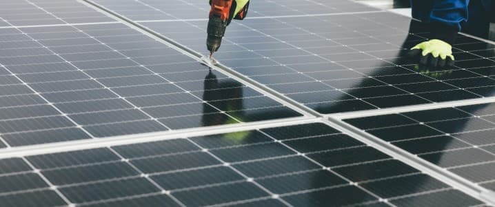 image of a person installing a solar panel