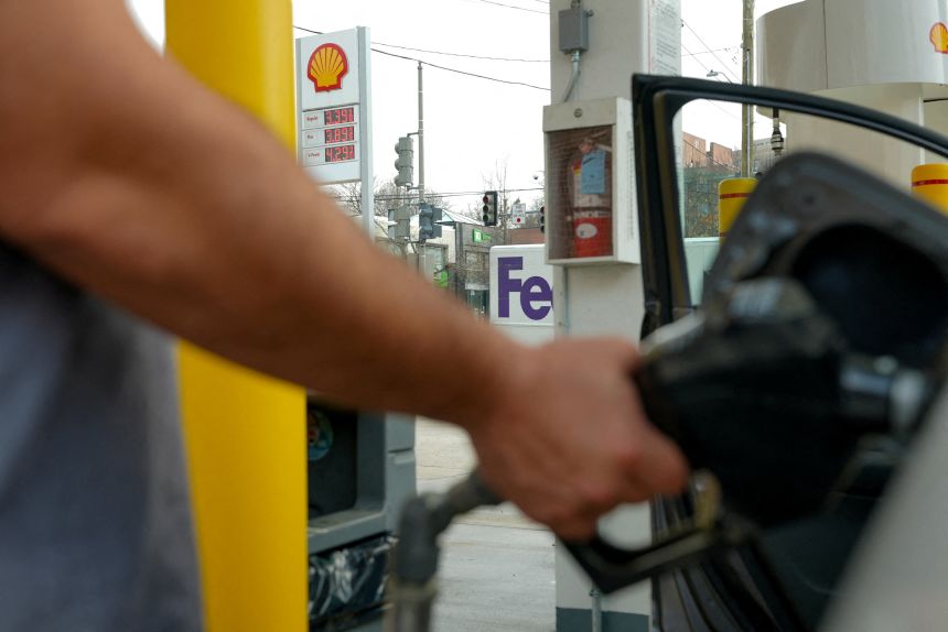 FILE PHOTO: A man pumps gas at a Shell station as the price of oil and gas has surged amid the U.S.-Israeli conflict with Iran, in Washington, D.C., on March 5, 2026.