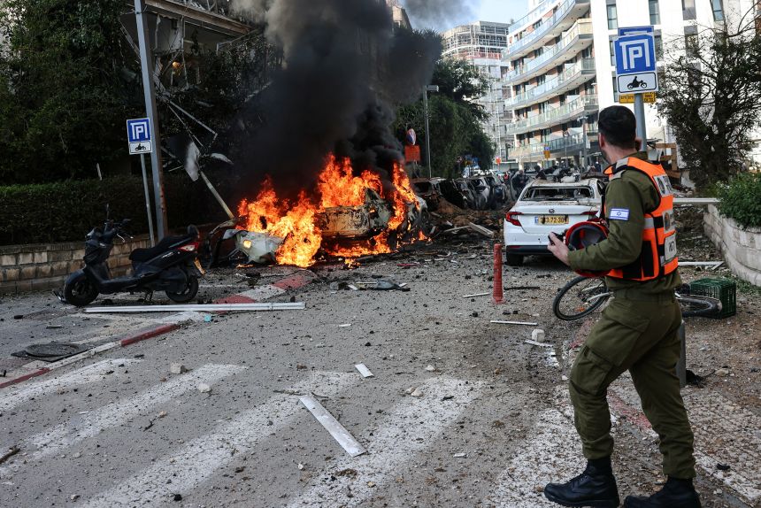 An emergency worker at a site following Iranian missile barrages in central Israel on Tuesday, March 24.