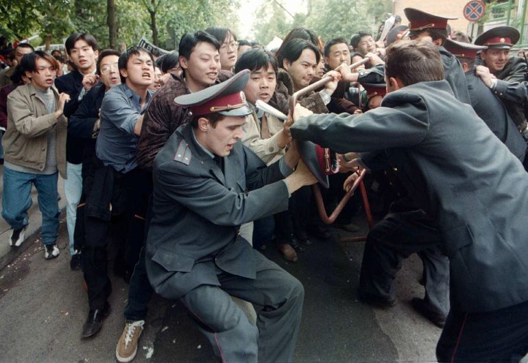 Chinese students break through a line of police officers at the US embassy in Kiev, Ukraine, 11 May 1999, during their protest against the bombing of the Chinese embassy in Belgrade