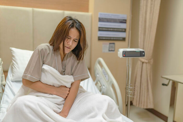 Patient in hospital bed appearing to fake illness, illustrating ridiculous cases of patients faking it according to medical pros online.