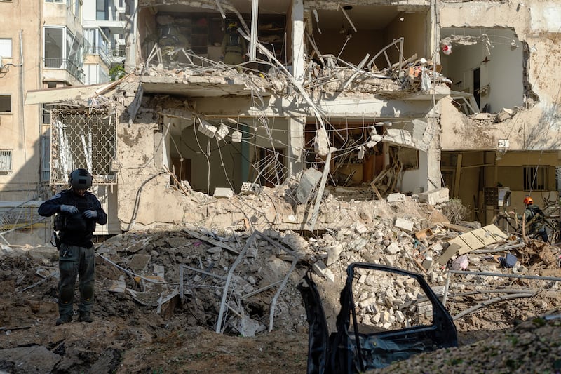 Emergency services attend the impact site of an Iranian missile on Tuesday in Tel Aviv, Israel. Photograph: Erik Marmor/Getty Images