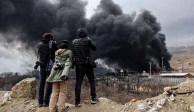 People record smoke rising after a reported strike on Shahran fuel tanks in Tehran, March 8, 2026.