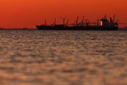 The silhouette of an oil and chemical tanker off the Gulf of Fos-sur-Mer at sunset, in Martigues, France, Friday.