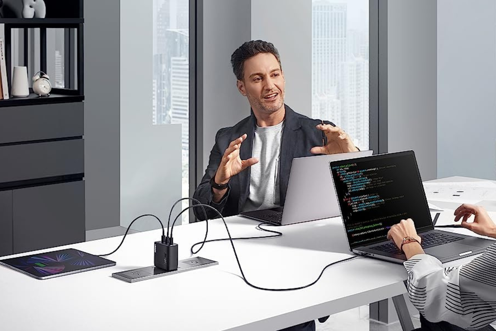 Anker 747 charger on desk powering two laptops and a tablet