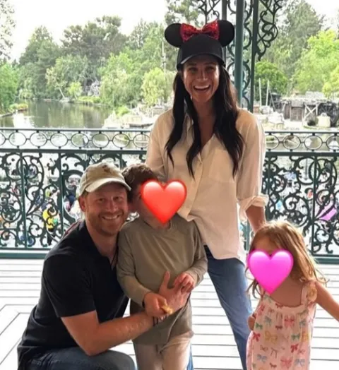 Meghan Markle, Prince Harry, and their two children with obscured faces at Disneyland.
