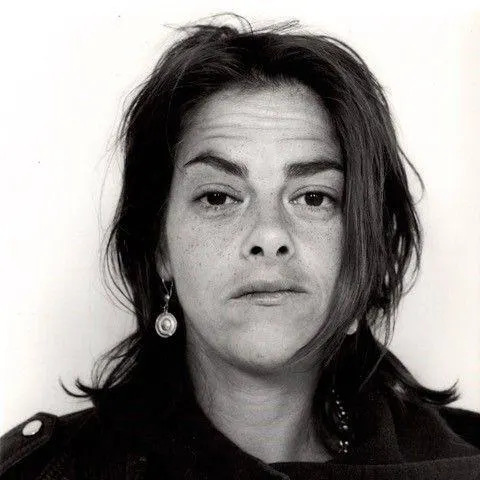 A head and shoulders portrait image of Dame Tracey Karima Emin. It is black and white. She is wearing a leather motorcycle jacket.