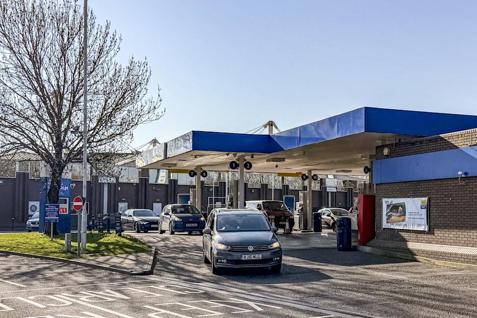 Vehicles queue to fill up at a petrol station in Bristol (PA) (PA Wire)