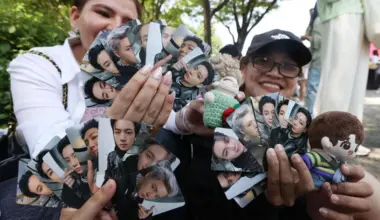 BTS' Army show off souvenirs at the 2024 BTS Festa, marking the septet's 10th anniversary, in South Korea on June 13, 2024.