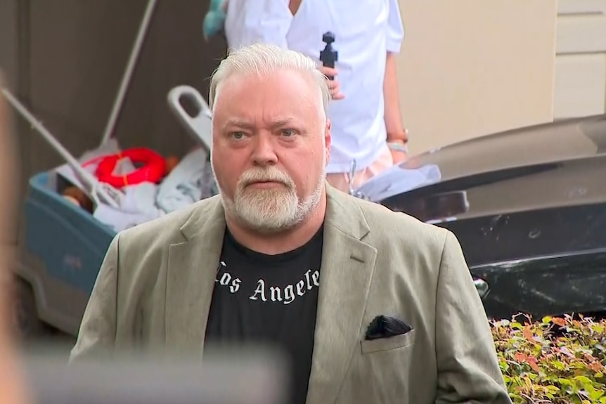 A photo of a middle aged shock jock with greying hair