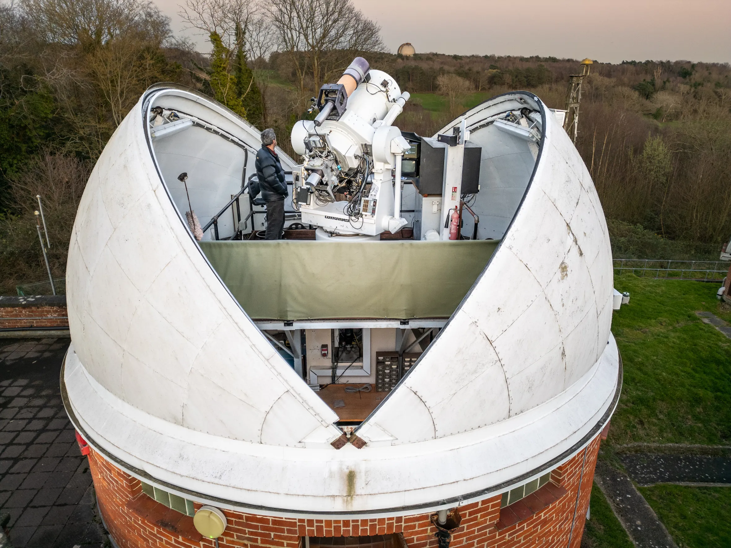 Rob Sherwood an International Laser Ranger uses lasers and telescopes to make laser range observations at the Space Geodesy Facility, Hertsmonceaux, East Sussex, UK.