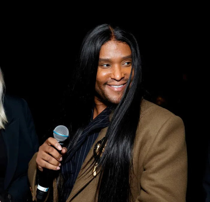 Law Roach smiling with a microphone in hand