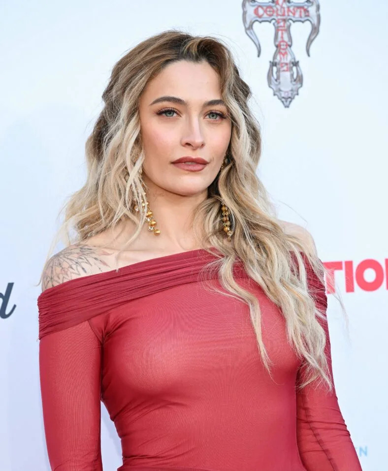 Paris Jackson in a red dress on red carpet. 
