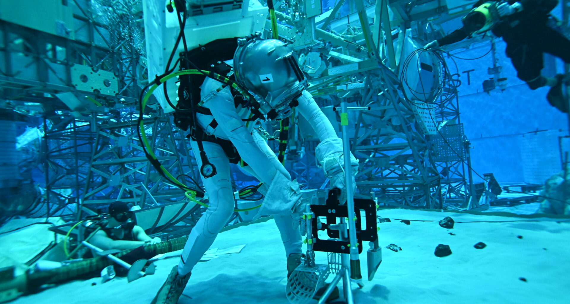 A person in a special underwater suit working with equipment in the NASA Buoyancy Lab