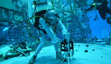A person in a special underwater suit working with equipment in the NASA Buoyancy Lab