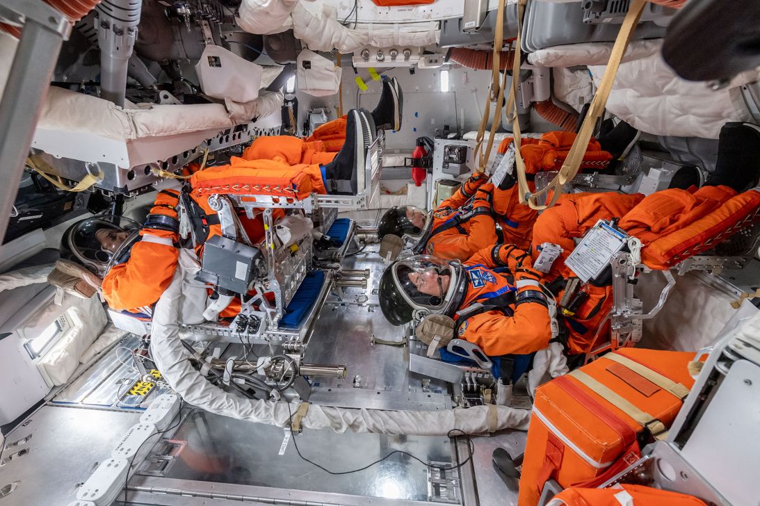 The Artemis II crew sit inside a mockup of the Orion capsule at NASA’s Johnson Space Center in Houston.