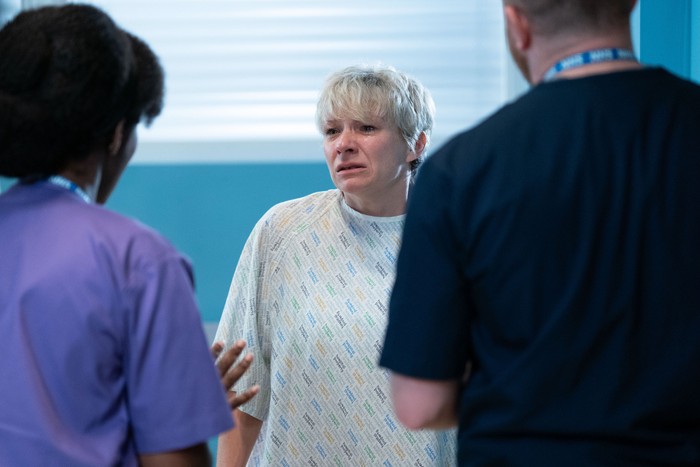 Nicola looking upset as she speaks with hospital staff in EastEnders