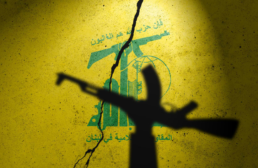  An illustrative image of a Hezbollah flag in the backdrop of an individual holding a weapon. 