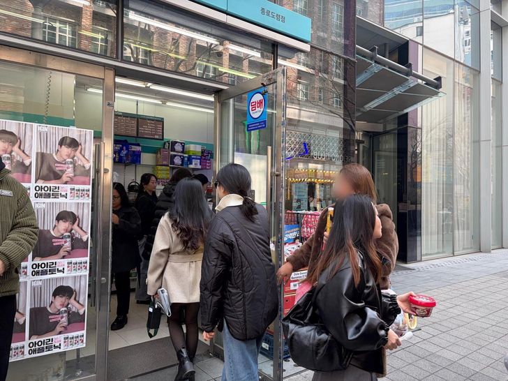A GS25 store in the Gwanghwamun area in Seoul with posters of BTS' Jin promoting IGIN highball on the store front is crowded with visitors, Sarturday. Courtesy of GS Retail 