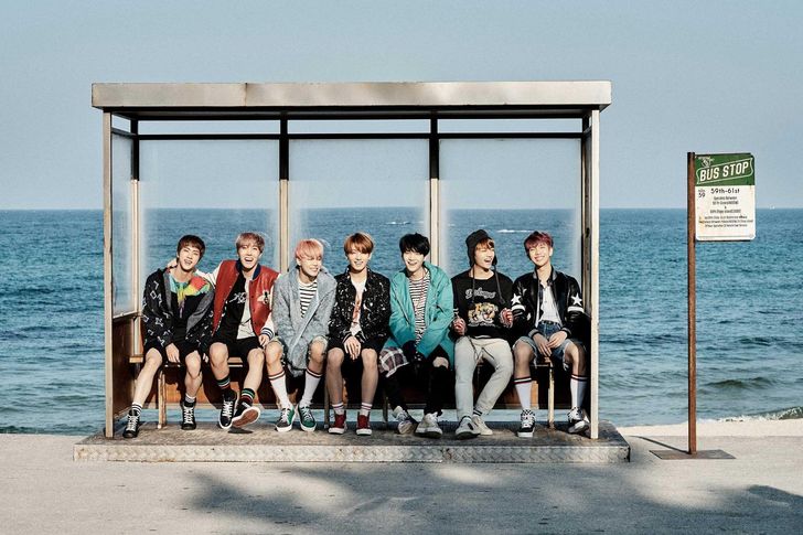 Members of K-pop boy band BTS pose at a bus stop in a promotional image released during the group’s 'You Never Walk Alone' era in 2017. The structure, installed at Hyangho Beach in Gangneung, Gangwon Province, later became a well-known travel destination for fans visiting Korea. Courtesy of BigHit Music