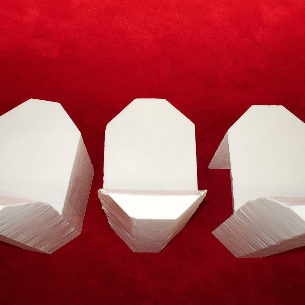 Geometric white foam shapes on a red surface.