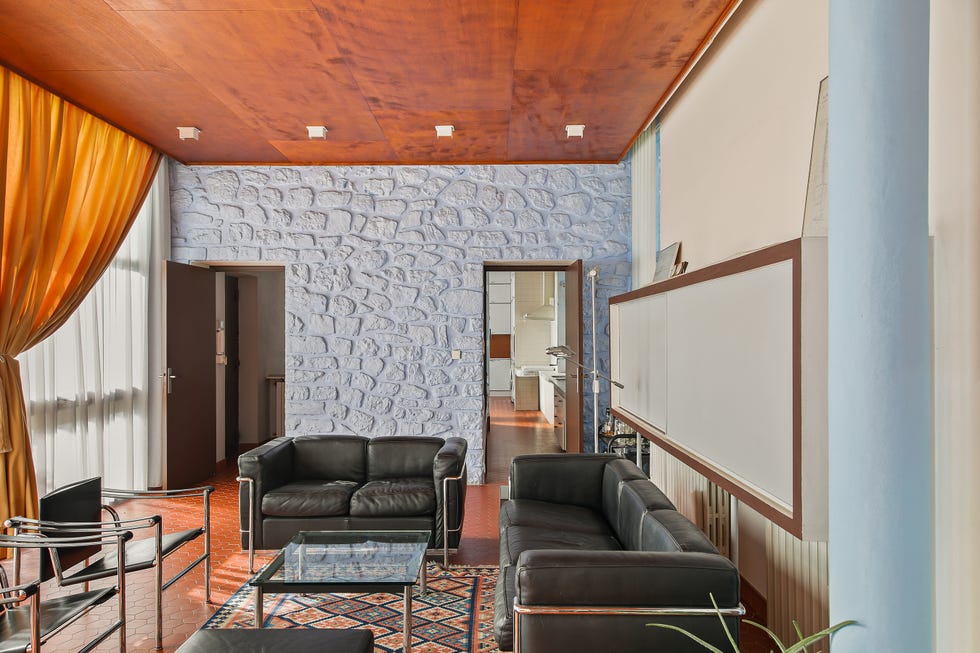 Modern living area with seating and vibrant curtains.