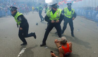 On the day of the Marathon bombings, police officers with their guns drawn reacted to the second explosion down the street. The first explosion knocked down a runner Bill Iffrig, 78, at the finish line of the Boston Marathon, on Apr. 15, 2013.