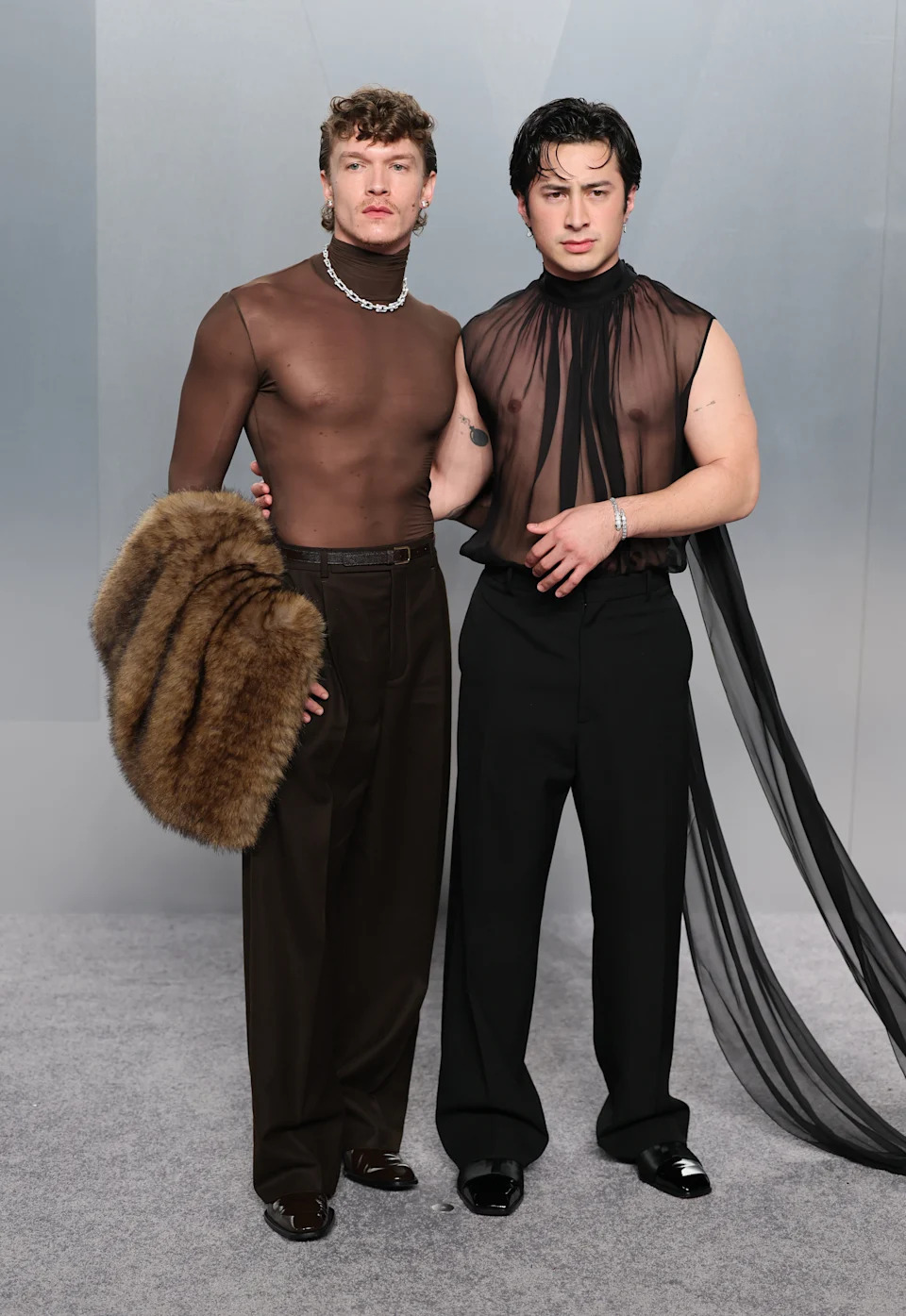Connor Storrie and Hudson Williams attend the 2026 Vanity Fair Oscars Party in sheer tops.