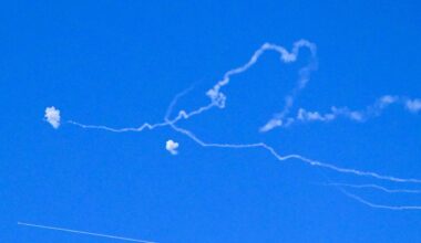 Emergency services respond following a rocket hit in central Israel on Monday, after rockets were launched by Hezbollah in Lebanon.