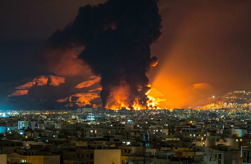 Smoke and flames rise at the site of airstrikes on an oil depot in Tehran on March 7, 2026. 