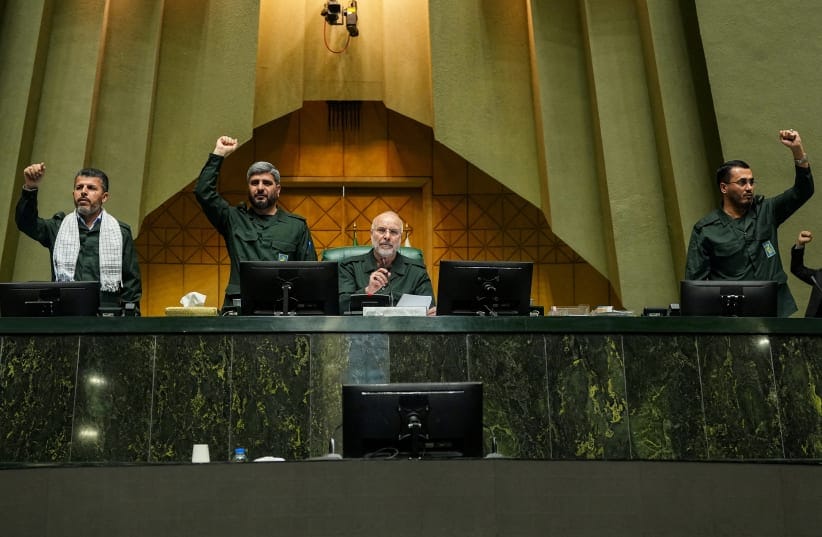 Iranian Parliament Speaker Mohammad Bagher Ghalibaf looks on as parliament members chant in support of the IRGC while wearing military uniforms in Tehran, Iran, February 1, 2026; illustrative.