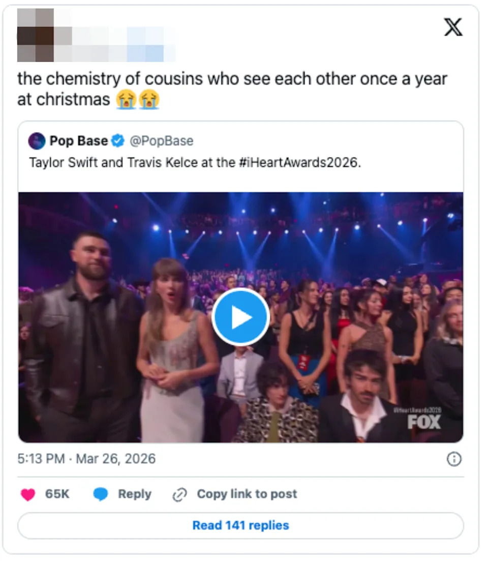 A crowd of people at an award show react with surprise and excitement. A play button overlays the image indicating video content